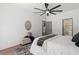 Bright bedroom features modern ceiling fan, complemented by a comfortable seating space at 1800 Loch Haven Ct, Trinity, FL 34655