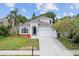 Charming home featuring a manicured front lawn, arched entryway, and an attached two-car garage at 1800 Loch Haven Ct, Trinity, FL 34655