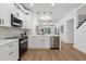 Contemporary kitchen featuring stainless steel appliances, sleek white cabinets, and marble backsplash at 1800 Loch Haven Ct, Trinity, FL 34655
