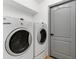 Bright laundry room with newer model washer and dryer at 1800 Loch Haven Ct, Trinity, FL 34655