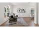 Sunlit living room boasts modern furnishings, hardwood floors, and stylish decorative accents at 1800 Loch Haven Ct, Trinity, FL 34655