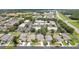 An aerial view of homes in a well-maintained neighborhood near a shopping center and highway at 1800 Loch Haven Ct, Trinity, FL 34655