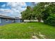 Lush backyard with mature trees and a white privacy fence at 1800 Pine St, Clearwater, FL 33764