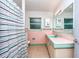 Bathroom with pastel tiles, vanity with sink and a combination shower and tub at 1800 Pine St, Clearwater, FL 33764