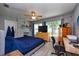 Inviting bedroom with a ceiling fan, gray accent brick wall, and large windows at 1800 Pine St, Clearwater, FL 33764