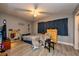 Bedroom with wood-look tile flooring, ceiling fan, and rocking chair with ottoman at 1800 Pine St, Clearwater, FL 33764