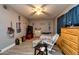 Cozy bedroom features a rocking chair, wood-look tile floors, and neutral gray walls at 1800 Pine St, Clearwater, FL 33764