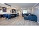 Open-concept living room featuring a large sofa, kitchen island, and tile floors at 1800 Pine St, Clearwater, FL 33764