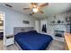 Bedroom features wood-look floors, ceiling fan, painted brick fireplace, and is adjacent to the updated kitchen at 1800 Pine St, Clearwater, FL 33764