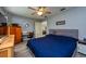 The main bedroom features wood-look floors, a ceiling fan and closet, and is staged with a desk at 1800 Pine St, Clearwater, FL 33764