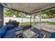 Relaxing screened porch with an outdoor kitchen and a view to the large fenced backyard with mature trees at 1800 Pine St, Clearwater, FL 33764