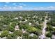 Aerial view of a neighborhood with lush greenery and distant city skyline at 1924 48Th S St, St Petersburg, FL 33711