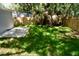 A backyard featuring a stone patio area and lush green grass at 1924 48Th S St, St Petersburg, FL 33711
