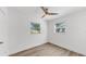 Clean bedroom with new flooring, two windows, and a ceiling fan at 1924 48Th S St, St Petersburg, FL 33711