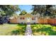 Charming single-story home featuring a well-maintained lawn and a walkway leading to the front door at 1924 48Th S St, St Petersburg, FL 33711