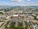 An aerial view of a community with tropical trees, a brick road and a view of the city skyline at 2010 E Palm Ave # 14303, Tampa, FL 33605