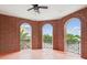Brick balcony featuring views of the neighborhood through arched openings and black metal railings at 2010 E Palm Ave # 14303, Tampa, FL 33605