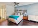 Bright bedroom featuring a large bed, hardwood floors, ceiling fan and natural light from the windows at 2010 E Palm Ave # 14303, Tampa, FL 33605