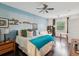 Inviting bedroom with a large bed, ceiling fan, hardwood floors, and natural light from the window at 2010 E Palm Ave # 14303, Tampa, FL 33605