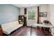 Comfortable bedroom with hardwood floors, large window, and modern decor at 2010 E Palm Ave # 14303, Tampa, FL 33605