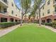 Beautiful courtyard featuring lush green space, manicured landscaping, and a charming water feature at 2010 E Palm Ave # 14303, Tampa, FL 33605