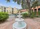Three-tiered fountain in a brick courtyard, adding a touch of elegance and tranquility at 2010 E Palm Ave # 14303, Tampa, FL 33605