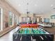 Recreational game room featuring a pool table, foosball table, and comfortable seating at 2010 E Palm Ave # 14303, Tampa, FL 33605