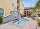Relax in the community hot tub, surrounded by lush landscaping and a decorative tiled fountain at 2010 E Palm Ave # 14303, Tampa, FL 33605
