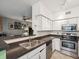 Kitchen featuring stainless steel appliances, white cabinets, and a breakfast bar with seating at 2010 E Palm Ave # 14303, Tampa, FL 33605