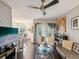 Open living room with modern ceiling fan, stylish decor, hardwood floors, and large windows for natural light at 2010 E Palm Ave # 14303, Tampa, FL 33605