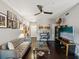Cozy living room featuring hardwood floors, stylish decor, modern ceiling fan, and ample natural light at 2010 E Palm Ave # 14303, Tampa, FL 33605