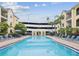 Inviting community pool with seating, umbrellas, and convenient access to parking at 2010 E Palm Ave # 14303, Tampa, FL 33605