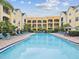 Beautiful community pool surrounded by lounge chairs and well-maintained landscaping at 2010 E Palm Ave # 14303, Tampa, FL 33605