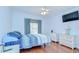 A bedroom features a window, ceiling fan, and matching nightstands at 2226 N Creek Ct, Sun City Center, FL 33573