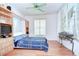 Comfortable bedroom featuring wood floors, a Murphy bed, and a ceiling fan for optimal relaxation at 2226 N Creek Ct, Sun City Center, FL 33573