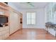 Bright bedroom features wood floors, a wall bed, and large windows for natural light and ventilation at 2226 N Creek Ct, Sun City Center, FL 33573