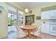 An eat-in kitchen features a sliding glass door and a breakfast table at 2226 N Creek Ct, Sun City Center, FL 33573