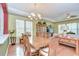 Elegant dining room with hardwood floors, large table with seating, and decorative lighting at 2226 N Creek Ct, Sun City Center, FL 33573