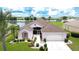 Charming single-story home with a well-manicured lawn, mature landscaping, and a lakeside view at 2226 N Creek Ct, Sun City Center, FL 33573