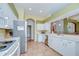 A kitchen has white cabinets, tile floors, stainless appliances and recessed lighting at 2226 N Creek Ct, Sun City Center, FL 33573