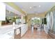 Bright kitchen with white cabinetry, a view to the dining area, and stainless appliances at 2226 N Creek Ct, Sun City Center, FL 33573