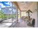Enjoy outdoor living on the screened lanai overlooking the garden, perfect for relaxation and entertaining at 2226 N Creek Ct, Sun City Center, FL 33573