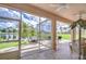 Relax on the screened lanai with views of the tranquil lake, lush landscaping, and comfortable seating at 2226 N Creek Ct, Sun City Center, FL 33573