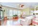 Bright living room with hardwood floors, comfortable seating, and large windows offering ample natural light at 2226 N Creek Ct, Sun City Center, FL 33573