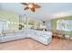 Spacious living room with open layout, hardwood floors, and seamlessly connected dining area and kitchen at 2226 N Creek Ct, Sun City Center, FL 33573