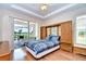 The main bedroom has an ensuite bath and a sliding glass door to the lanai at 2226 N Creek Ct, Sun City Center, FL 33573