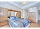 A bedroom features a tray ceiling, hardwood floors, and built in cabinets at 2226 N Creek Ct, Sun City Center, FL 33573