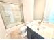 This modern bathroom features a sleek vanity, shower with glass enclosure and neutral tiling at 31889 Tortuga Shore Loop, Wesley Chapel, FL 33545