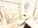 Bright bathroom featuring a glass enclosed shower, tiled walls, and a decorative wreath, complemented by a modern vanity at 31889 Tortuga Shore Loop, Wesley Chapel, FL 33545