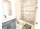 This bathroom offers a sleek glass-enclosed shower, updated vanity and neutral color palette at 31889 Tortuga Shore Loop, Wesley Chapel, FL 33545